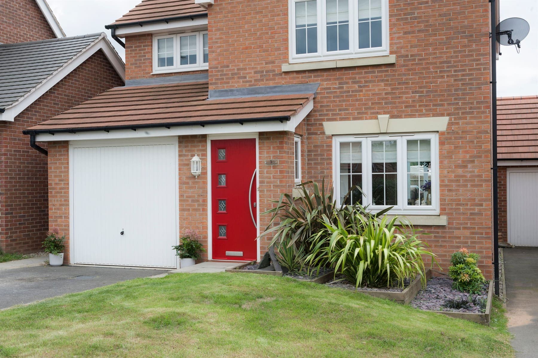 Portavelle Wenlock composite front door in Red shown on a house